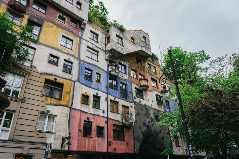 multiple multicolored buildings are grouped together in the city