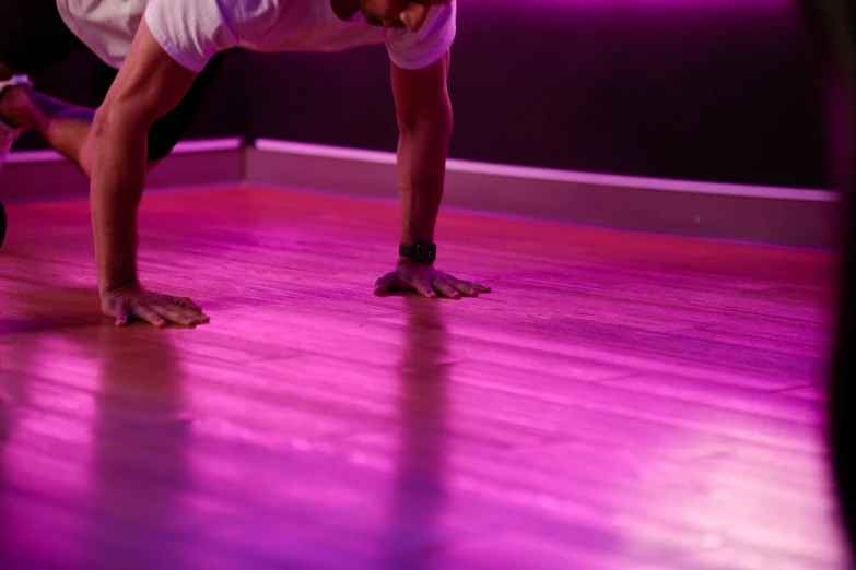 an image of a person doing a handstand on wooden floor