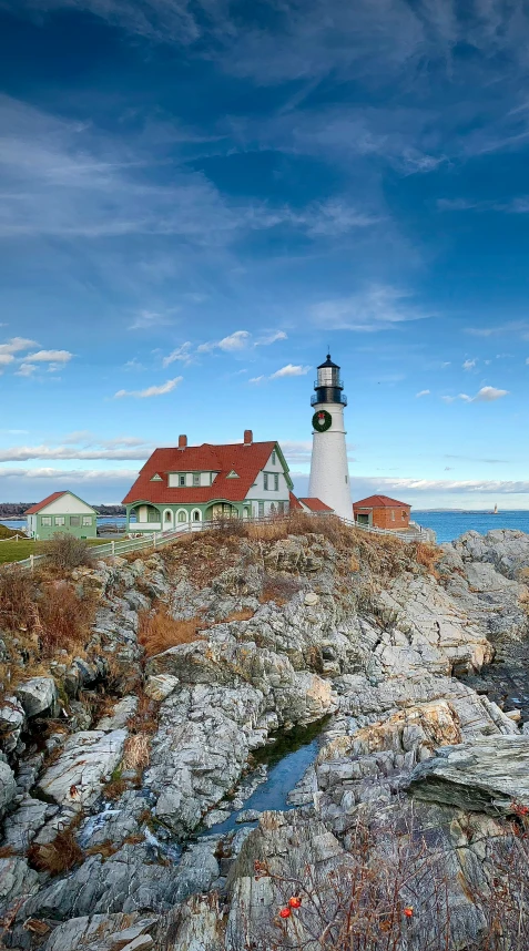 a lighthouse on top of a rocky hill