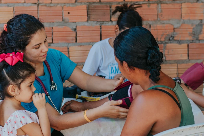 a girl and a woman having medical attention