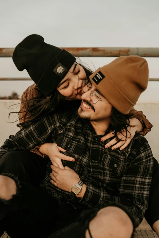 a couple hugs as they sit on a bench