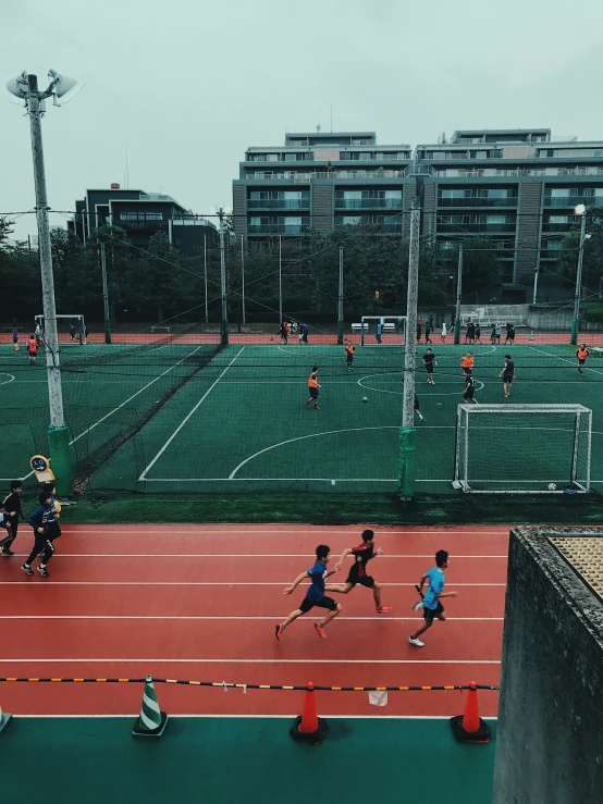 a group of people playing a game on a tennis court