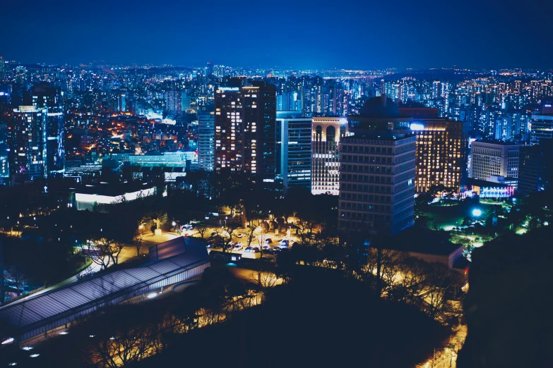 a night view shows skyscrs and buildings in the city