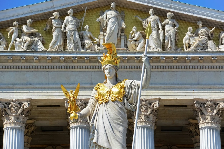 a statue with a large crown in front of a building