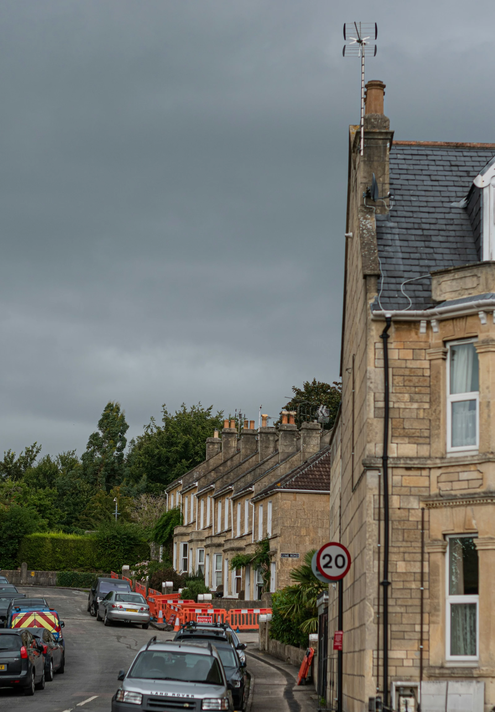 the street is lined with cars and houses