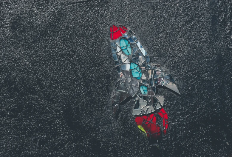 aerial pograph of a red and black umbrella on a rainy day