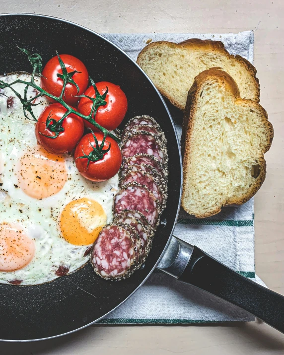 eggs and ham sit on a pan with toast