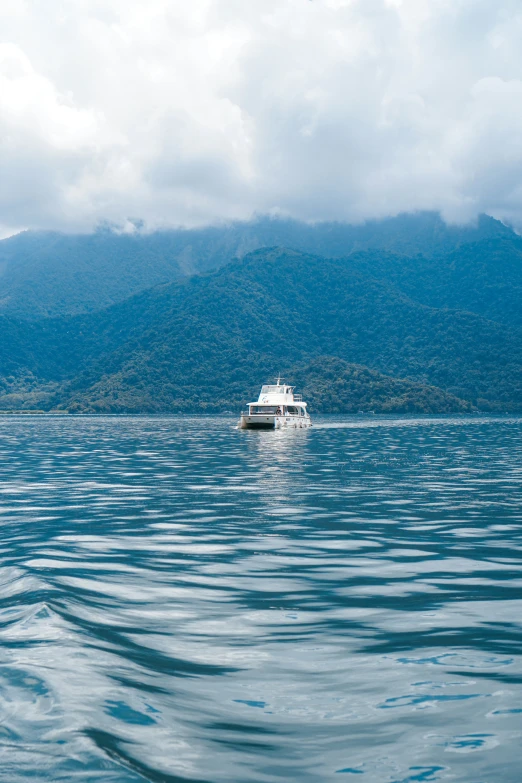 a boat sitting out in the middle of a body of water