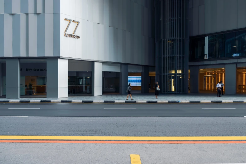 people walking in front of an office building