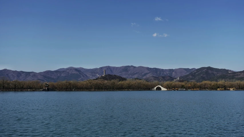 a body of water with mountains in the background