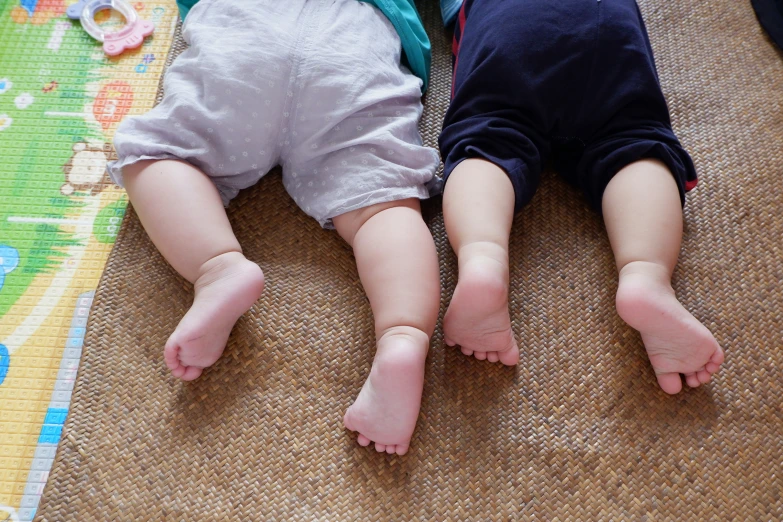 two little s lie down with their legs up