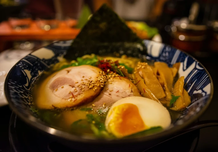 a bowl with various food inside and a green garnish on top of it