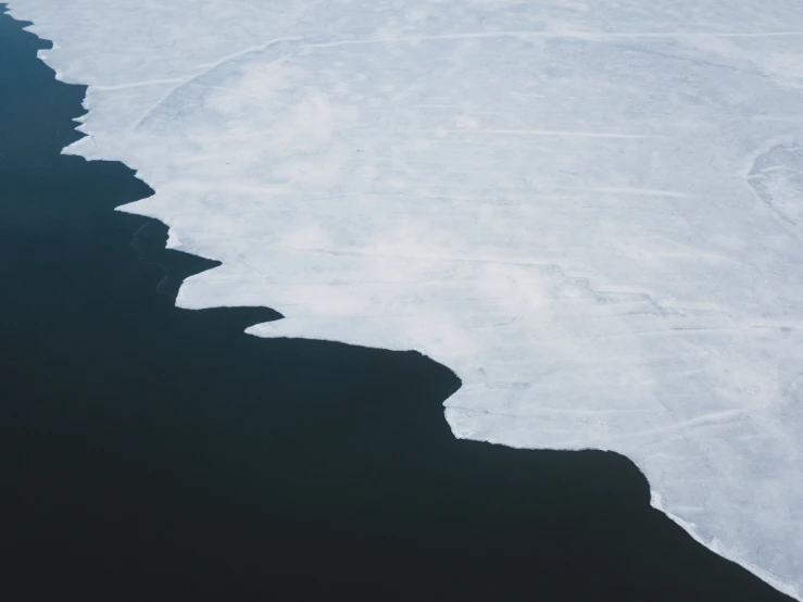 ice covered ocean with shadow on ground