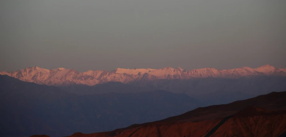 the view from a distance shows the snow capped mountains