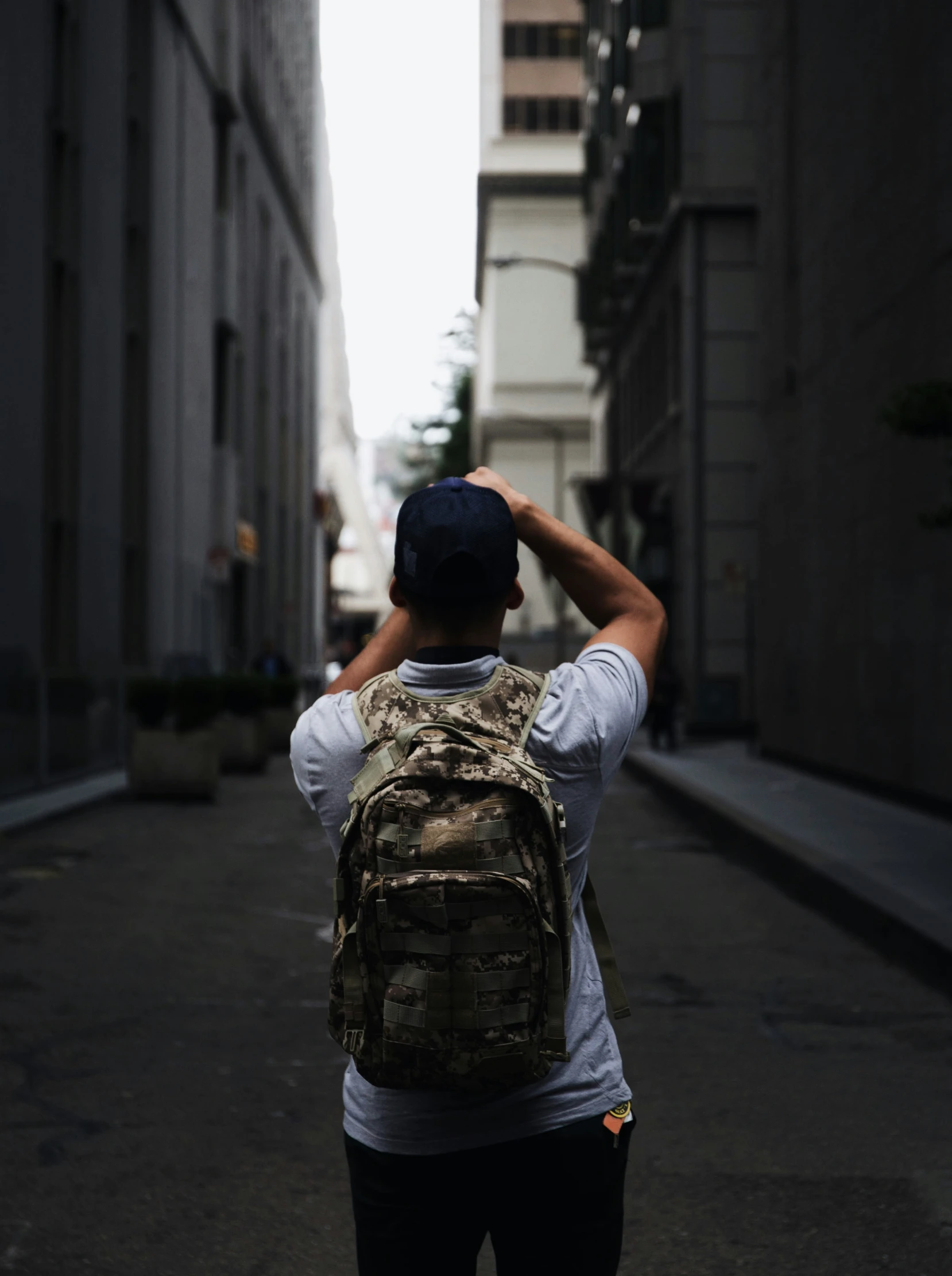 a person with a backpack walks through a street