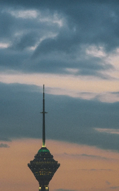 a city street light next to a tall tower