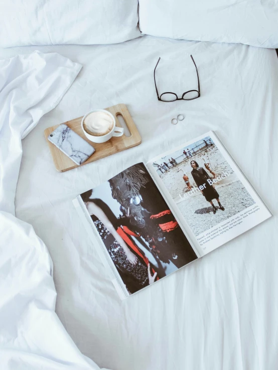 a magazine sitting on top of a white bed