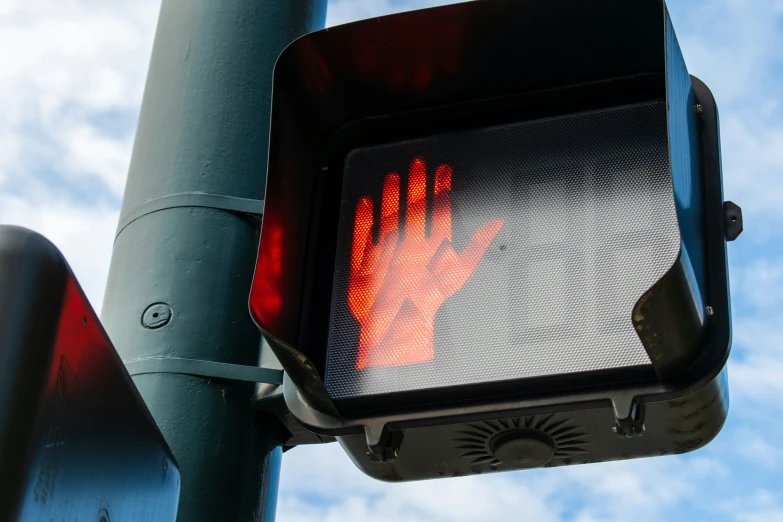 there is a traffic signal that appears to have red hands on it