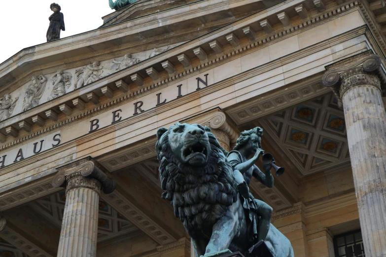 an old architectural building with statues on top