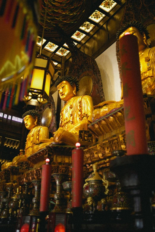 golden statues in the shape of people with light up hands