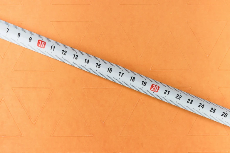 a ruler on an orange background, with different designs