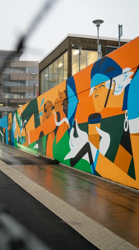 a wall painted with the colors of people and sports equipment