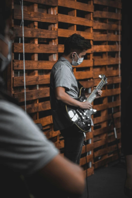 a man that is holding a guitar in his hands