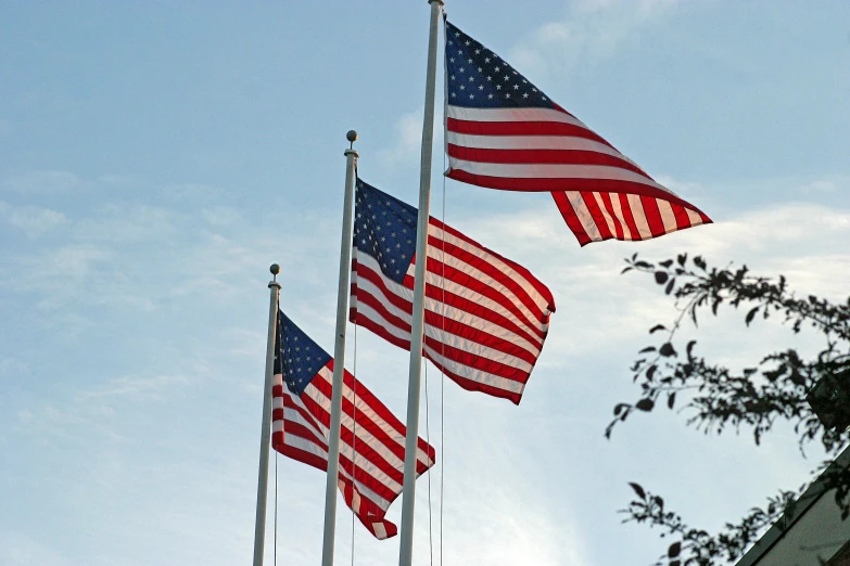 five american flags are flying high in the sky