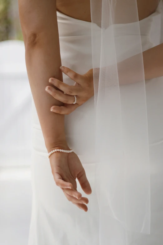 a bride and groom holding hands with a veil