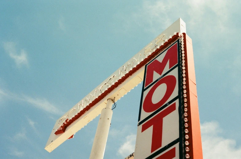 a street sign with a sky background behind it