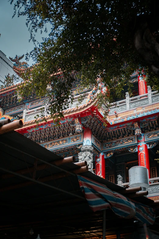 a red building with a tree in the background