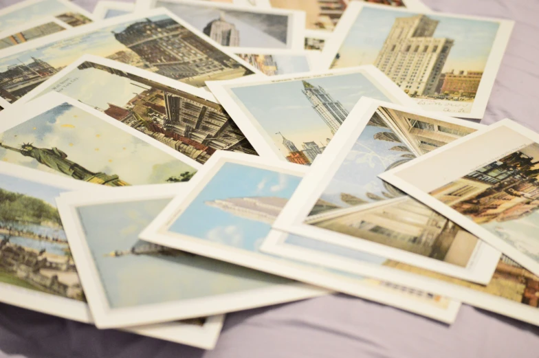 a table topped with lots of small postcards