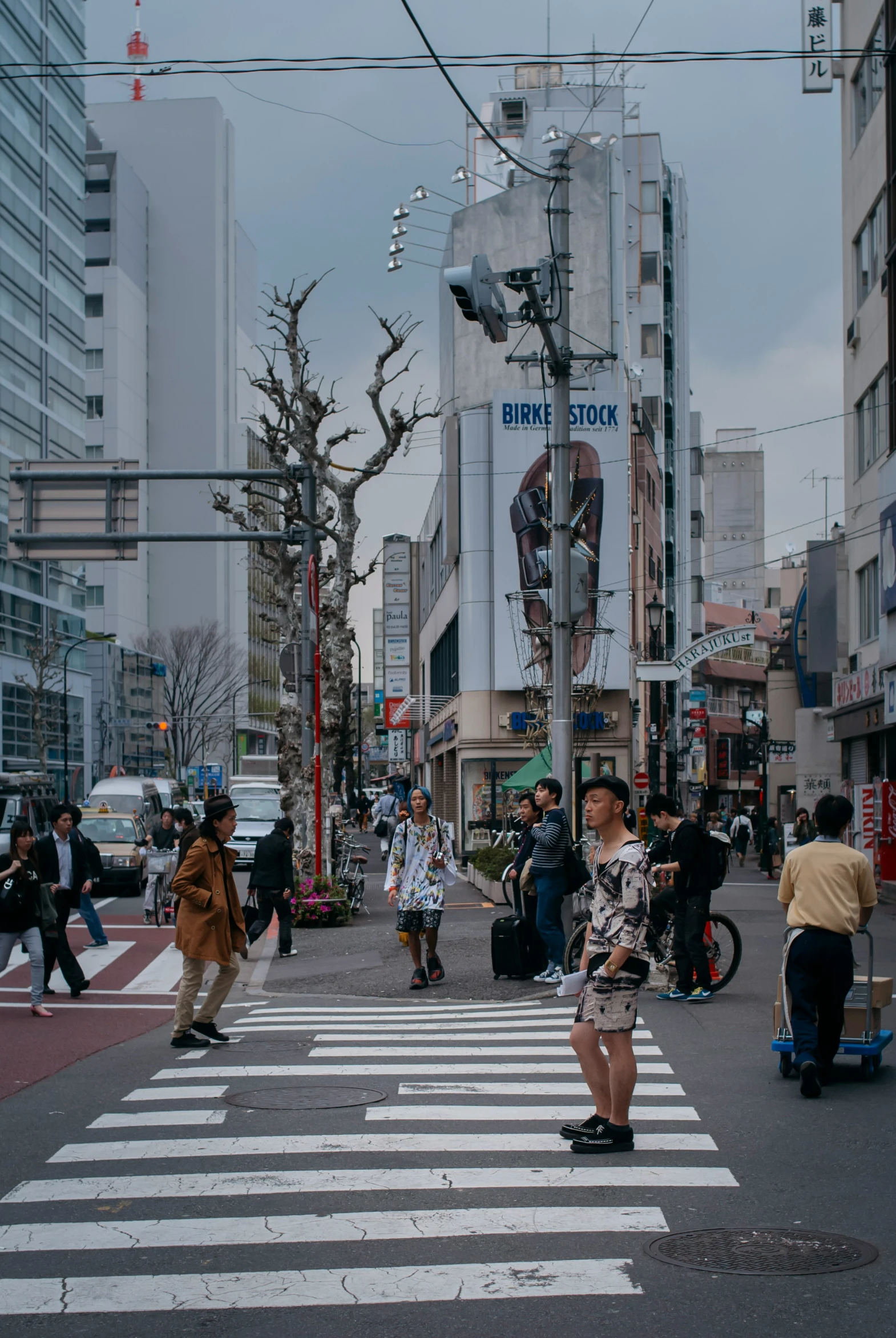 people crossing the street at an intersection in a city