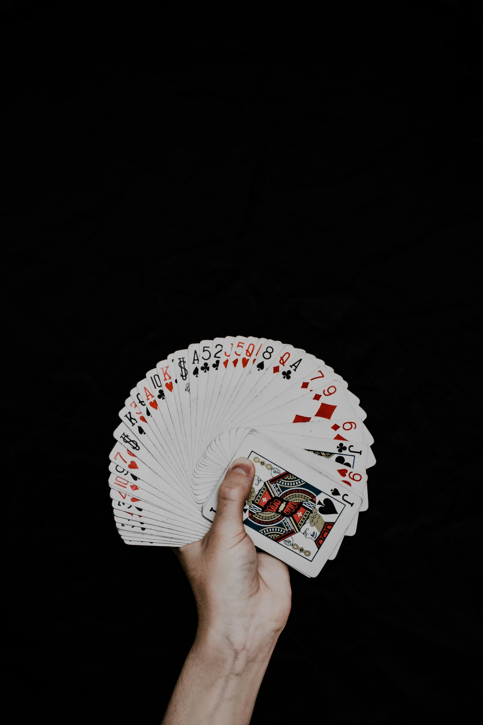 a person holding onto some playing cards