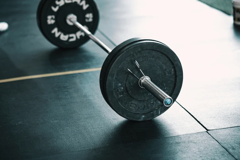 a cross bar sitting behind a gym weight