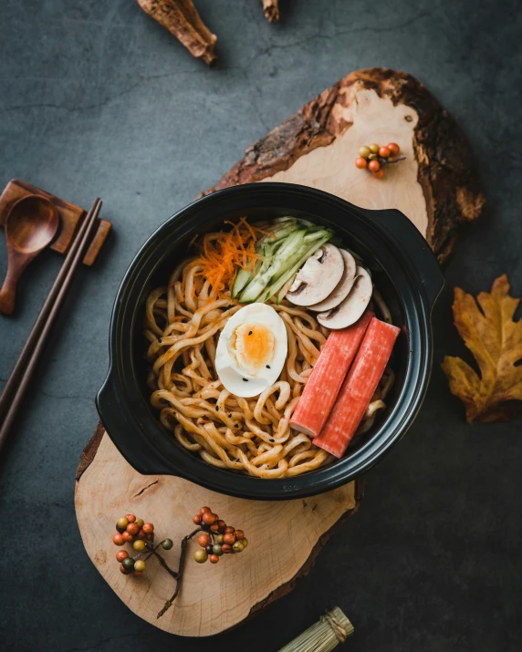 an asian dish consisting of noodles, chopsticks, and mushrooms