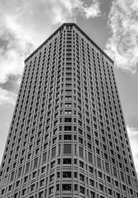 a very tall building against the sky with many windows