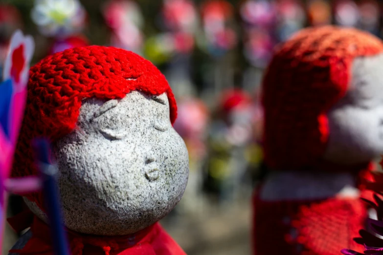 two knitted animals are displayed outside during the day