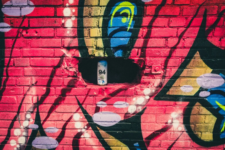 a graffiti covered wall with a sign saying stop