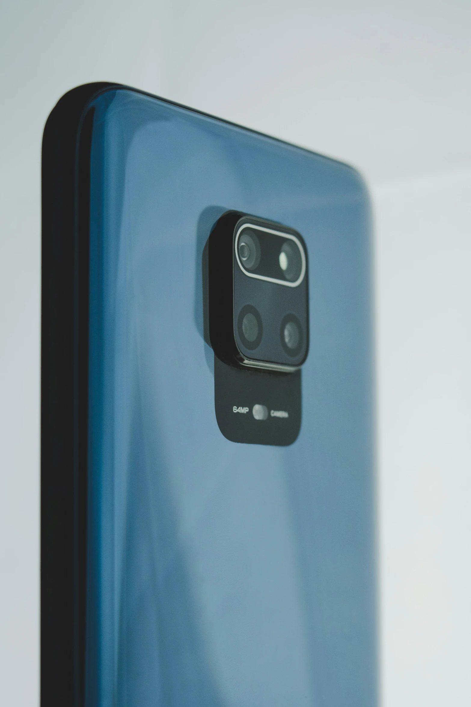 a close up of the back side of a blue phone