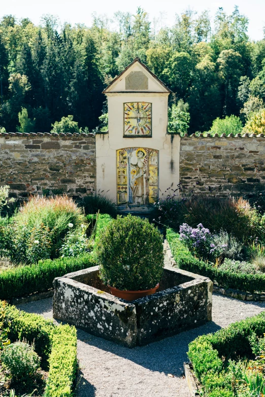 the formal garden has hedges around it