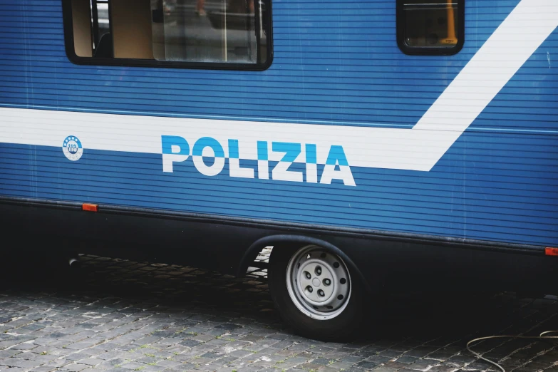 a blue and white police vehicle parked on the side of the street