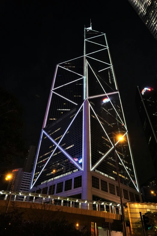 the large modern building is illuminated with colored lights