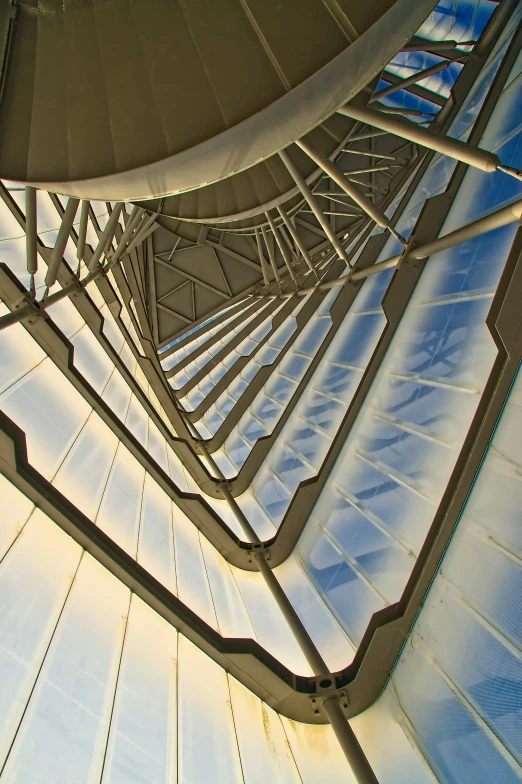 looking up at the metal structure in which stairs are set to be suspended