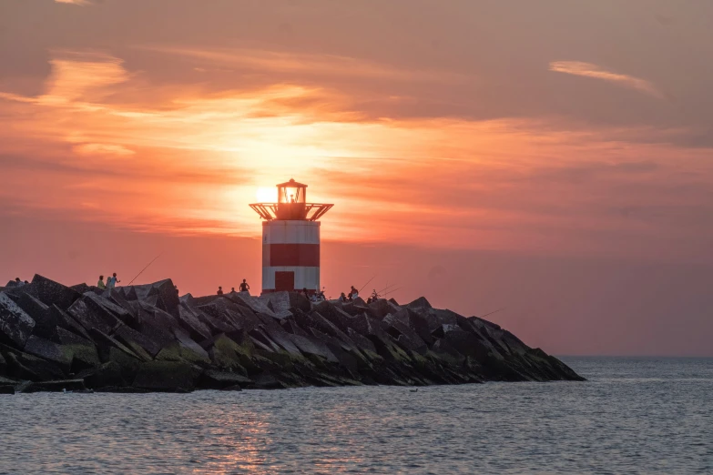 a sunset over the water with an island on top