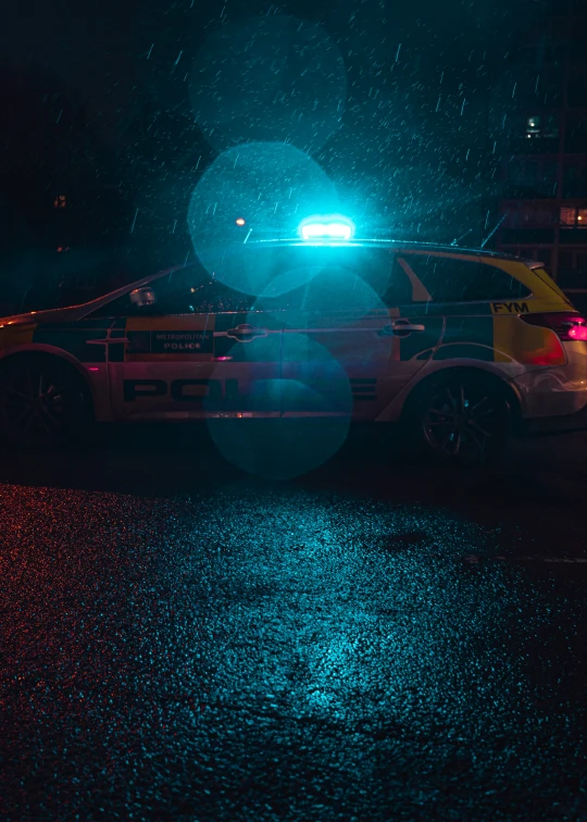 a vehicle parked on a wet, dark street