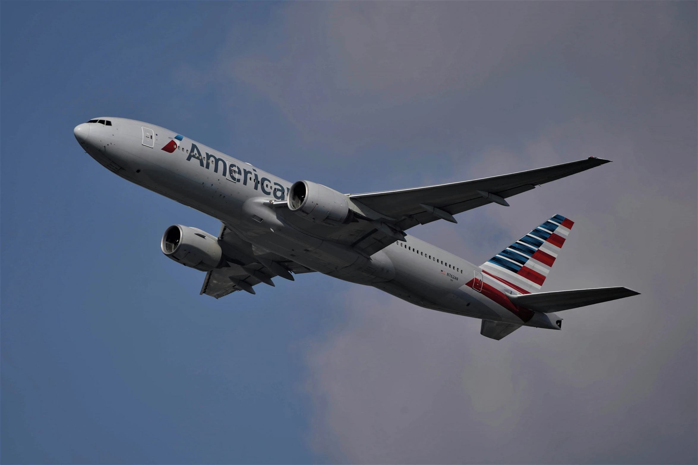 an american airlines passenger jet flies high in the sky