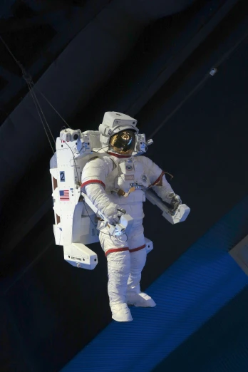 an astronaut floating in the air holding onto the strings