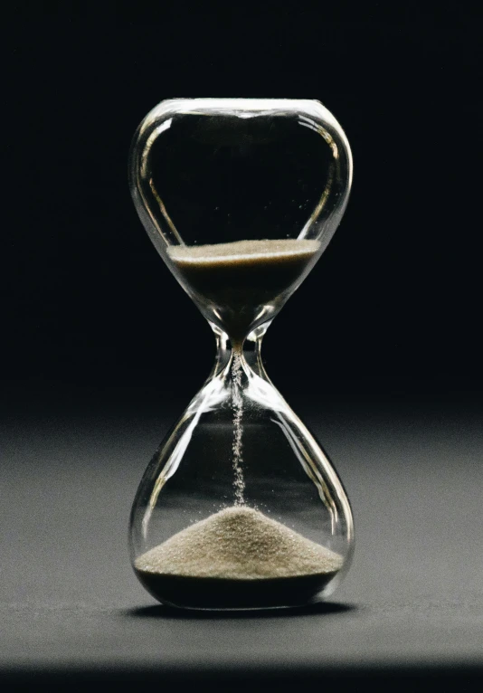 an hourglass is shown in dark light