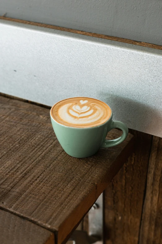 a cup of latte art sitting on a table